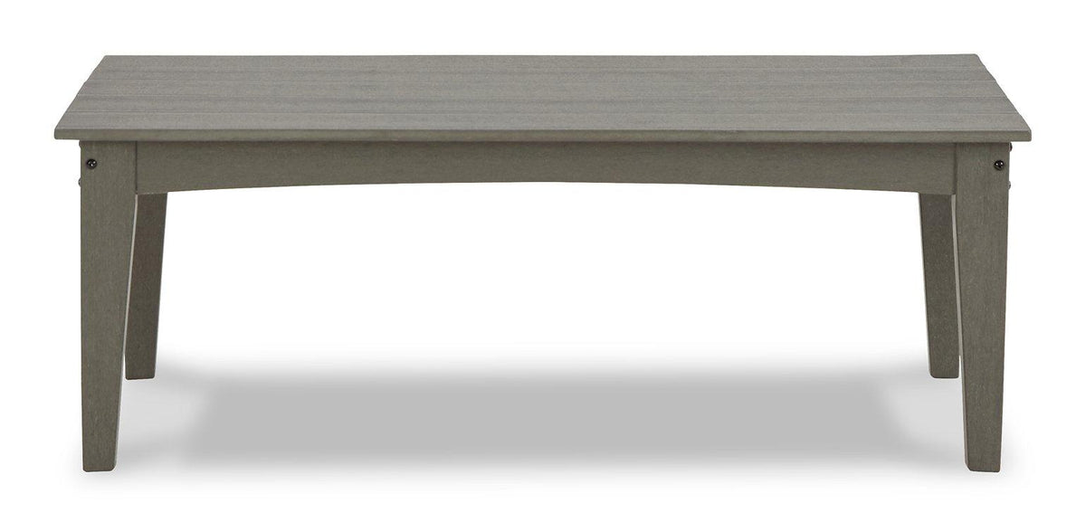 Ashley Furniture Visola outdoor loveseat and coffee table set with cushioned seating and a glass-top coffee table in a patio setting.