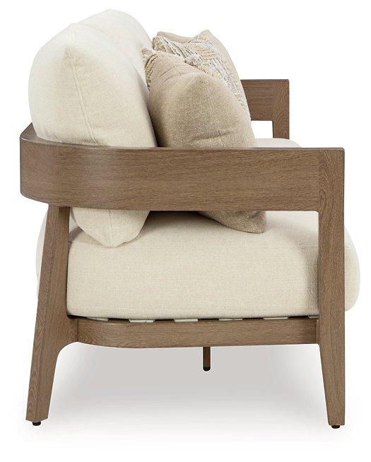 Ashley Furniture Serene Bay outdoor sofa with cushioned seating and armrests, ideal for patio relaxation and outdoor lounging.