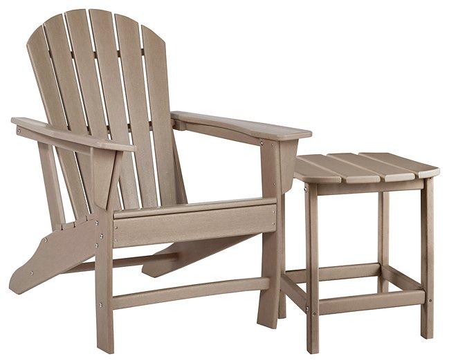 Outdoor table set by Ashley Furniture featuring a glass-top table and matching chairs in a sunny outdoor setting.