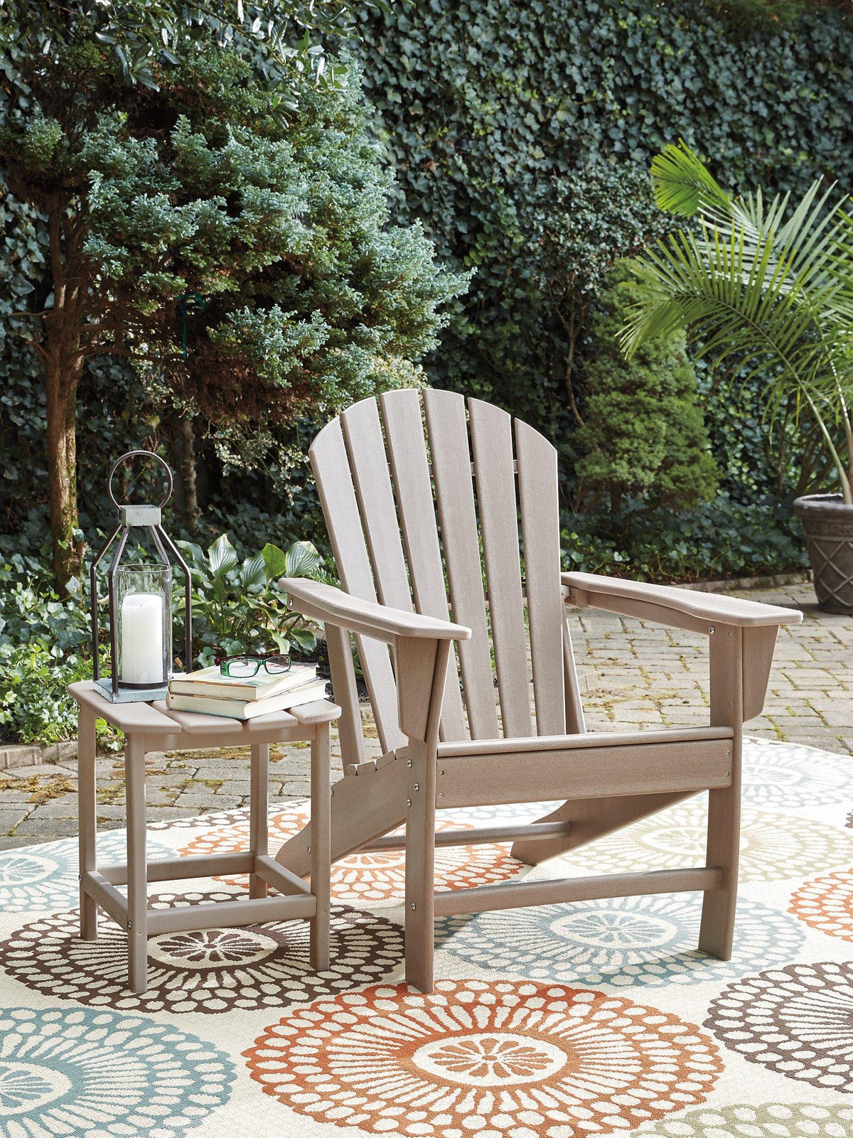 Outdoor table set from Ashley Furniture featuring a dining table and matching chairs in a sunny outdoor setting.