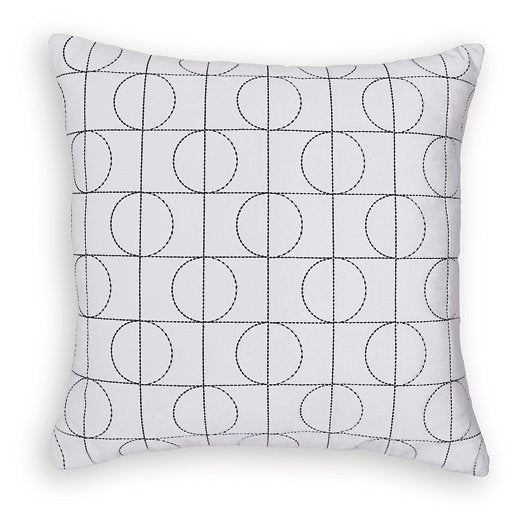 Set of four Ashley Furniture Kydner pillows with decorative fabric covers, arranged on a sofa for stylish comfort.