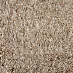 Ashley Furniture Gariland Pillow with textured fabric and decorative stitching, showcased on a neutral-colored sofa.