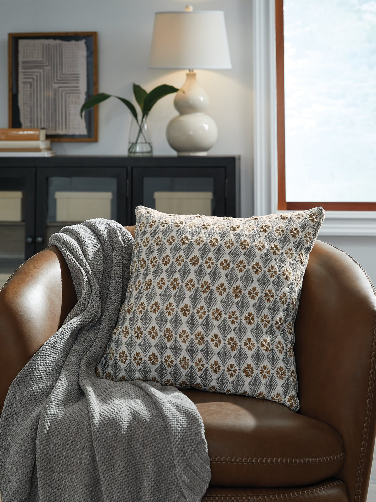 Set of four Ashley Furniture Dainwick pillows with soft fabric covers and decorative patterns for cozy home decor.