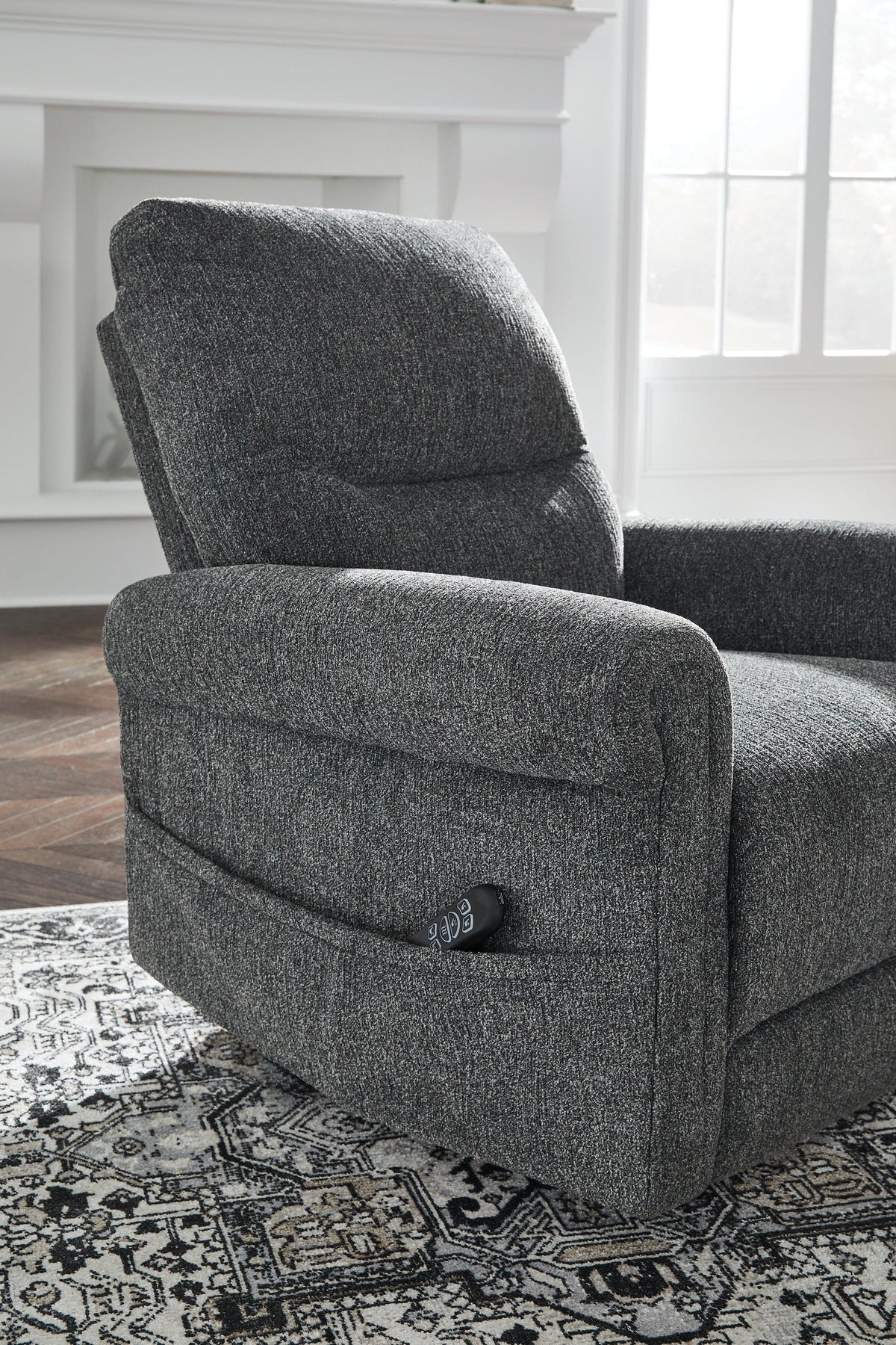 Ashley Furniture Aureta power lift recliner with plush upholstery and padded armrests, shown in a relaxed reclined position.