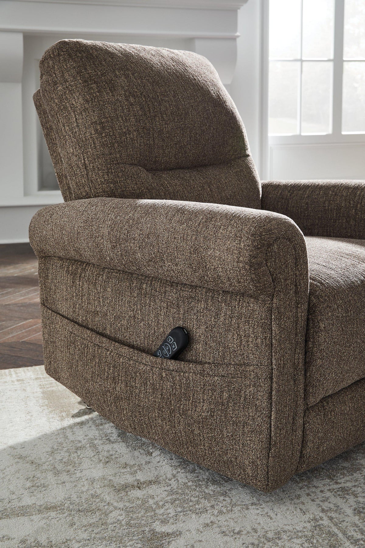 Ashley Furniture Aureta Power Lift Recliner in neutral fabric, featuring plush cushioning and a sturdy wooden base.