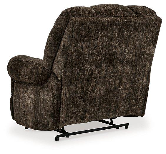Comfortable Ashley Furniture Movie Man recliner with plush cushioning and dark fabric upholstery, ideal for relaxing in living rooms.