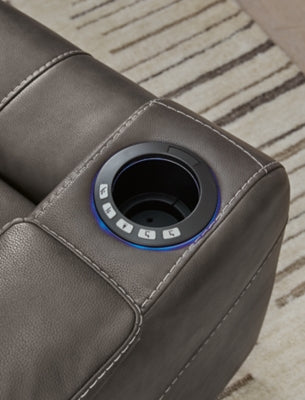 Ashley Furniture Feazada power recliner with plush armrests, cup holders, and headrest in dark leather upholstery.