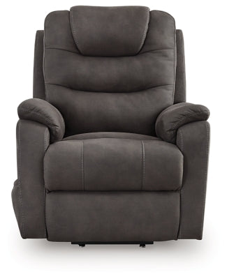 Ashley Furniture Snowfield Power Lift Recliner with plush fabric, padded armrests, and a reclining mechanism for added comfort.