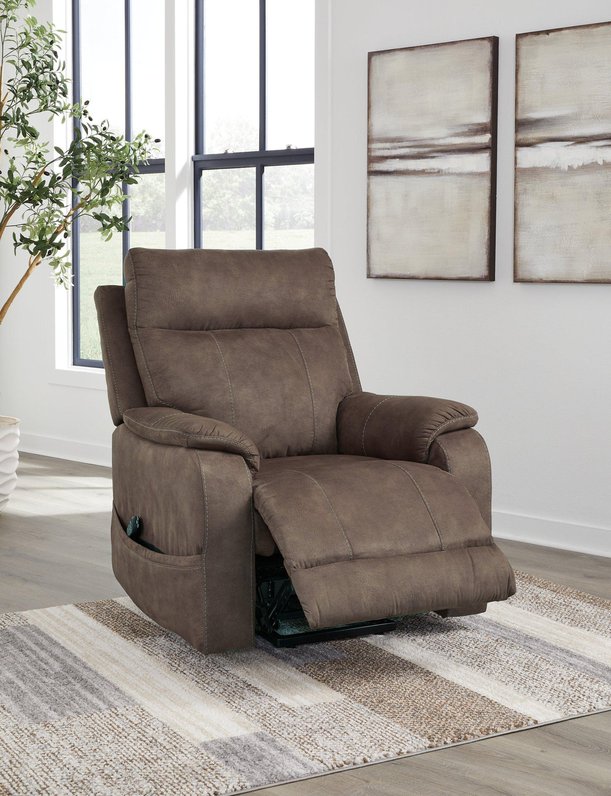 Ashley Furniture Crestmeade Power Lift Recliner in dark upholstery with plush cushioning and a sturdy metal frame.