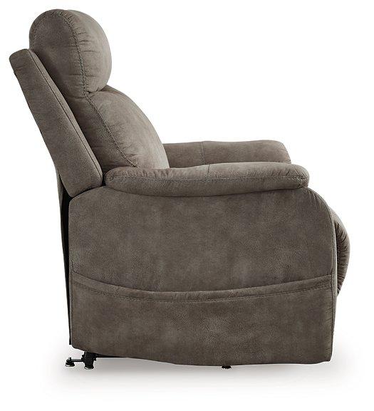 Ashley Furniture Crestmeade Power Lift Recliner in neutral fabric showing the recliner with extended footrest and plush cushioning.