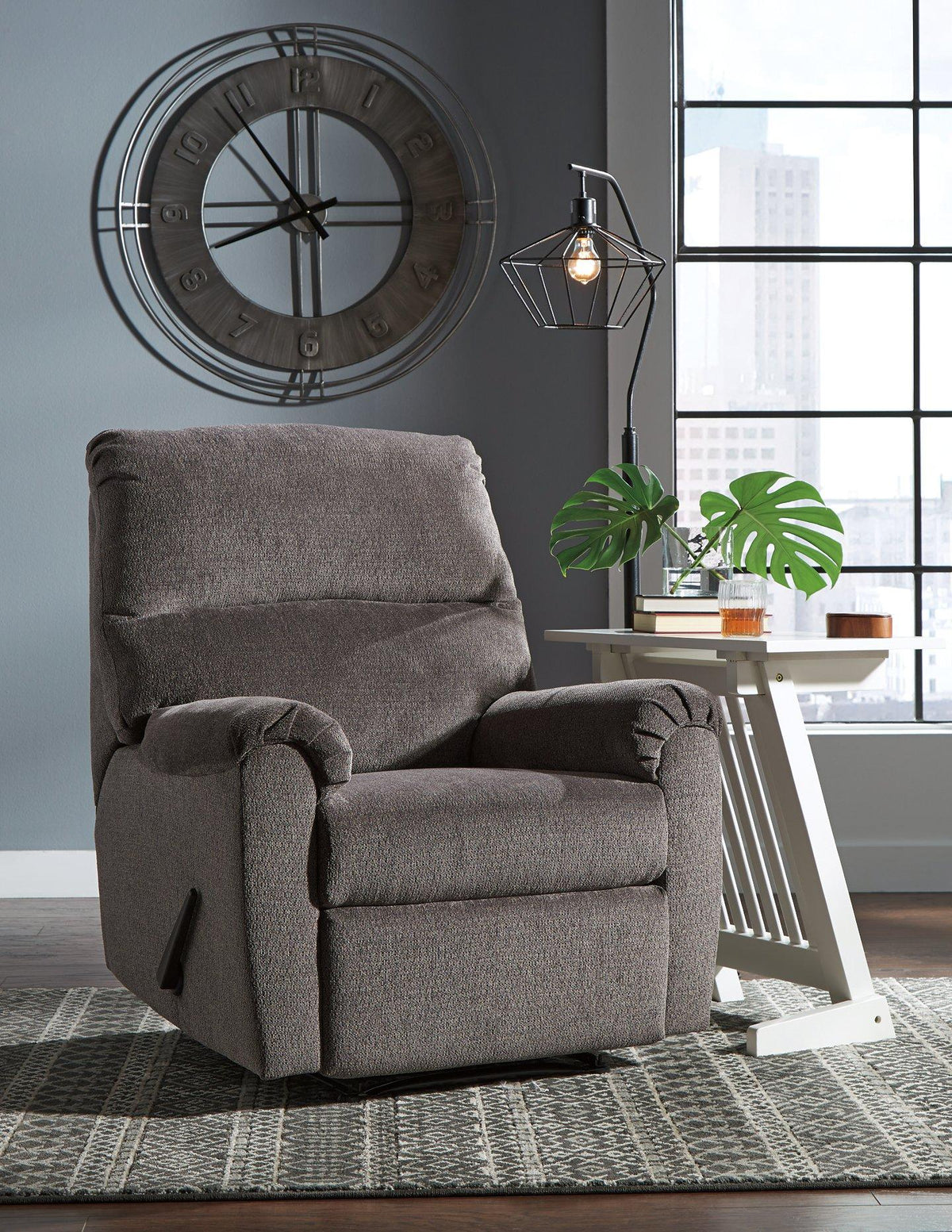 Ashley Furniture Nerviano recliner with plush fabric upholstery and padded armrests, shown in a cozy living room setting.