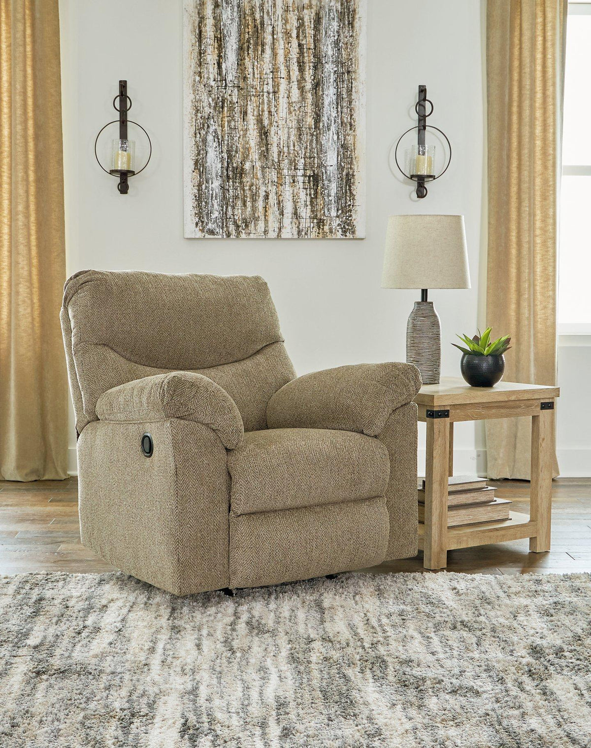 Comfortable Alphons Recliner by Ashley Furniture with plush fabric and cushioned armrests, perfect for relaxing in your living room.