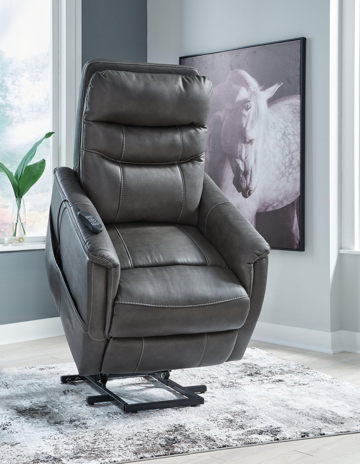 Ashley Furniture Strawbill Power Lift Recliner in tan fabric with plush cushioning and a built-in recline and lift mechanism.
