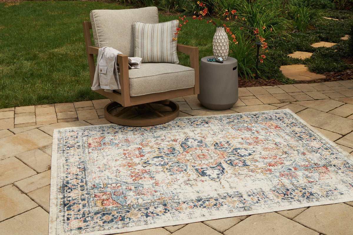 Ashley Furniture Jarrpage Rug with intricate geometric patterns in neutral tones on a plush area rug surface.