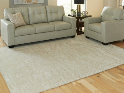 Ashley Furniture Jaseena area rug with intricate patterns in warm tones, perfect for adding style to living spaces.