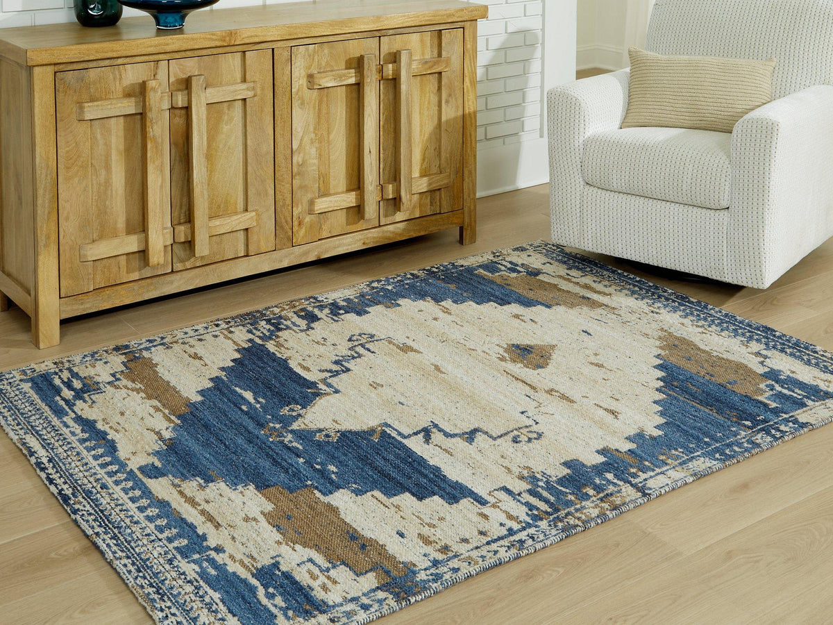 Ashley Furniture Varnler Rug featuring a textured, patterned design in neutral tones, perfect for living room or bedroom decor.