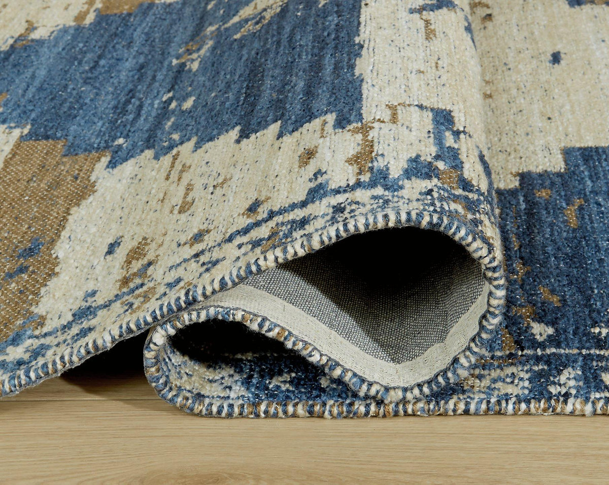 Varnler Rug by Ashley Furniture featuring a plush, patterned design perfect for adding cozy style to living spaces.