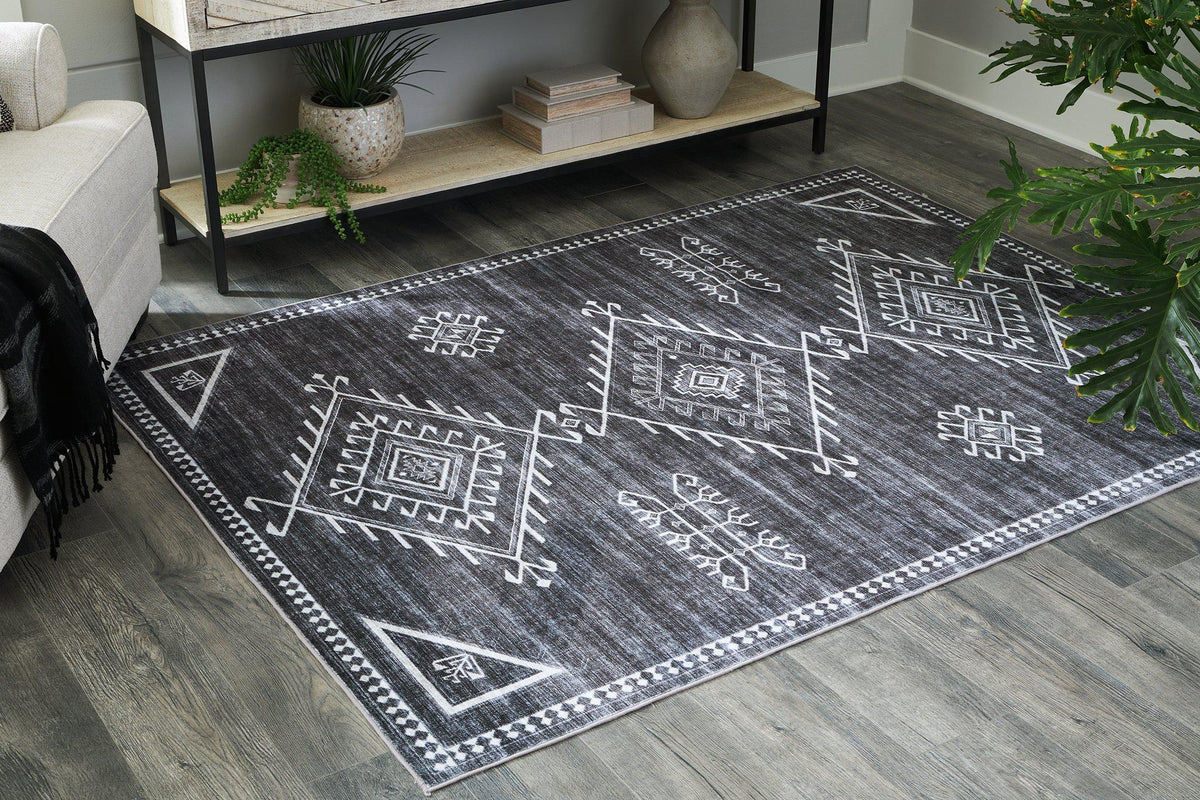 Ashley Furniture Arloman Rug with intricate patterns and soft texture, perfect for adding style to living spaces.
