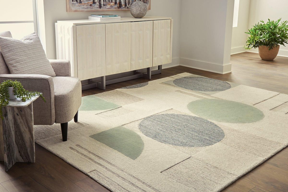 Ashley Furniture Dallane 8x10 rug with intricate pattern in neutral tones, showcasing soft, woven texture and decorative design.