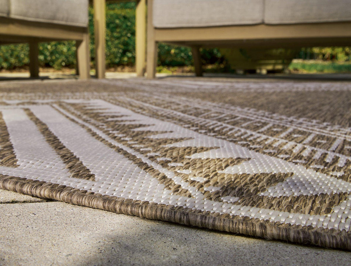 Ashley Furniture Dunsler 5' x 7' rug with intricate patterns and soft texture, ideal for adding style to living spaces.