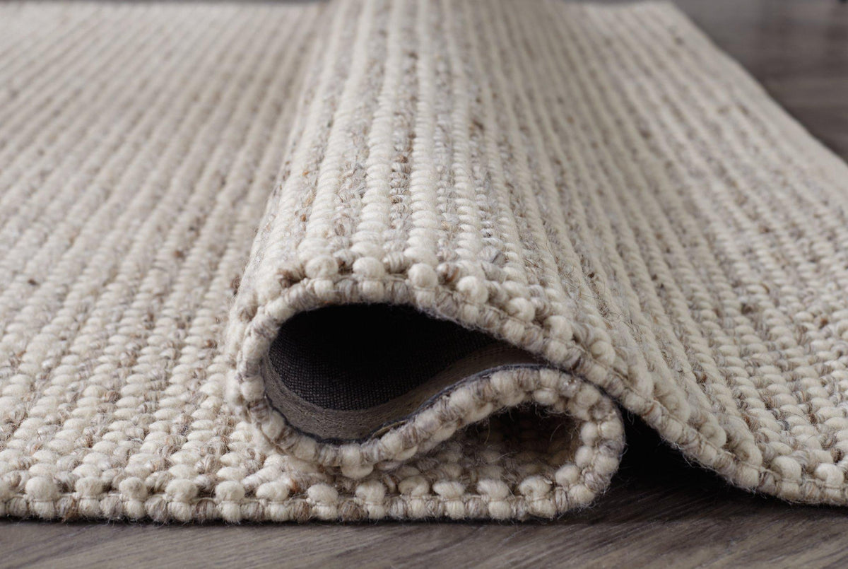 Ashley Furniture Jossick 5x7 rug with intricate patterns in neutral tones, ideal for living rooms or bedrooms.