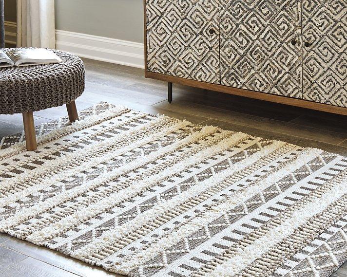 Ashley Furniture Karalee 8' x 10' rug with intricate patterns and soft textures, ideal for enhancing living room decor.