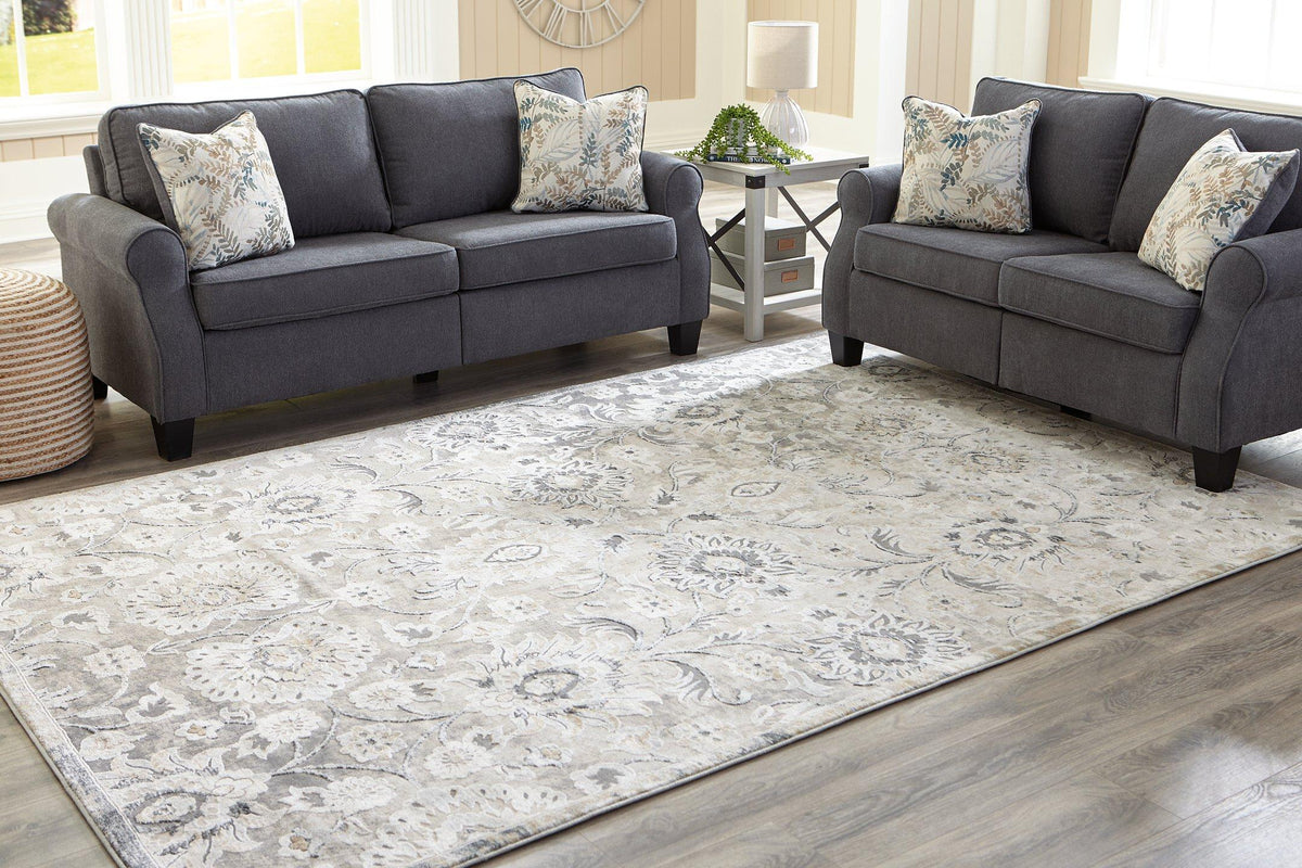 Ashley Furniture Kilkenny rug, 7'10" x 10'2", featuring a detailed woven design in neutral tones, ideal for living rooms or bedrooms.