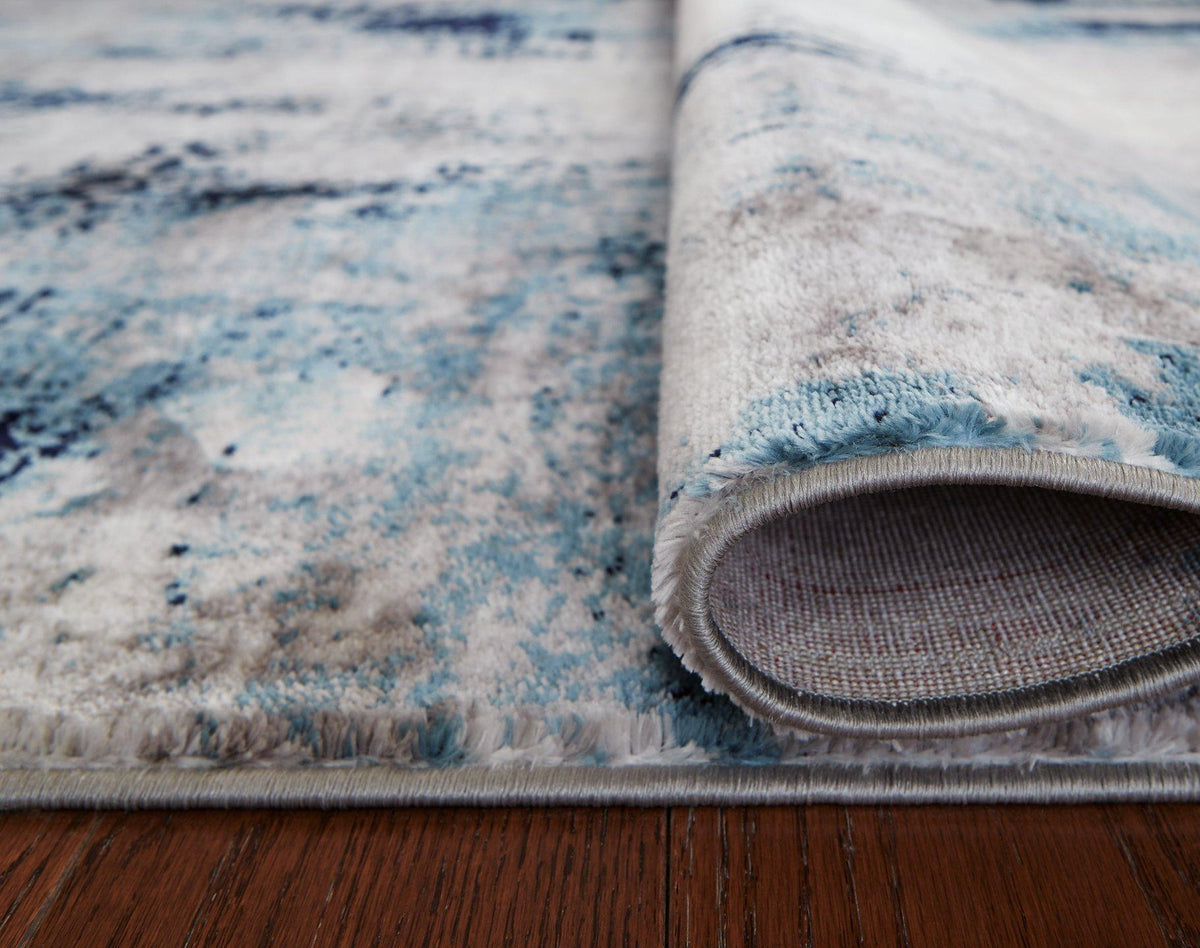 Ashley Furniture Leonelle 5'3" x 7'3" rug with a stylish pattern, perfect for living rooms or bedrooms.