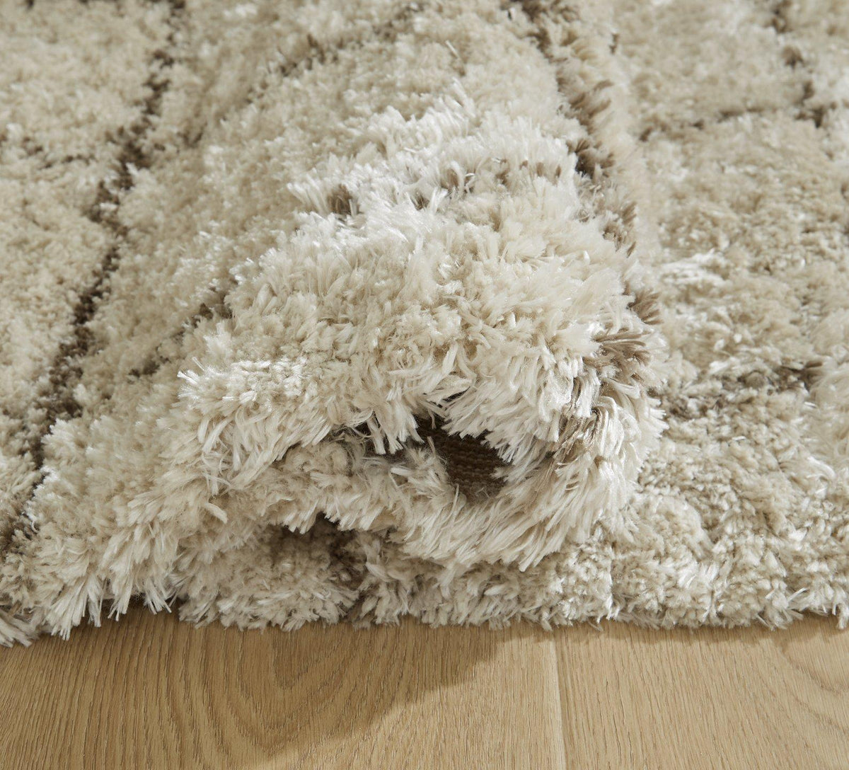 Ashley Furniture Wrenlow Rug with intricate patterns in warm neutral tones, ideal for living room or bedroom decor.