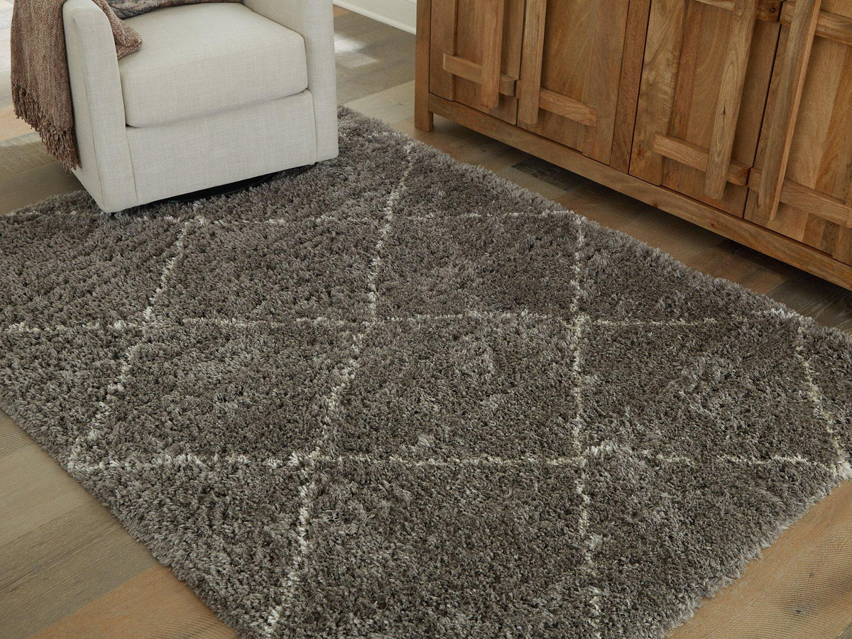 Wrenlow Rug by Ashley Furniture featuring a soft, patterned design in neutral tones for cozy living room decor.