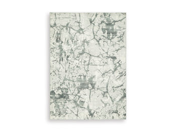 Medium washable area rug by Ashley Furniture featuring a stylish design, perfect for adding comfort to living spaces.