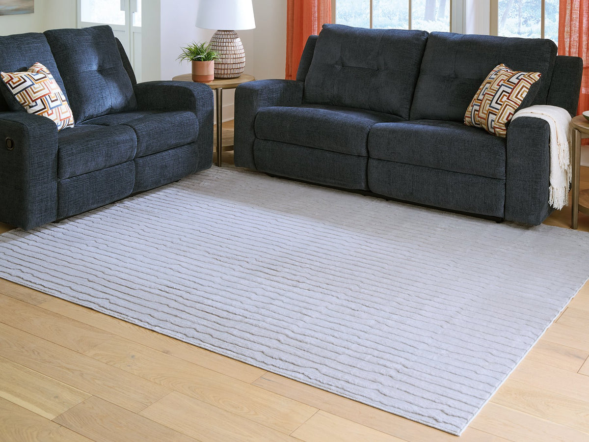 Medium Worthley washable area rug by Ashley Furniture with a neutral, textured design suitable for living rooms or bedrooms.