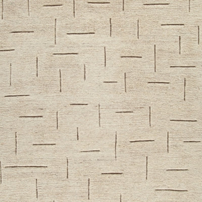 Ashley Furniture Clayman Rug swatch showing textured beige and brown woven fabric for living room or bedroom decor.