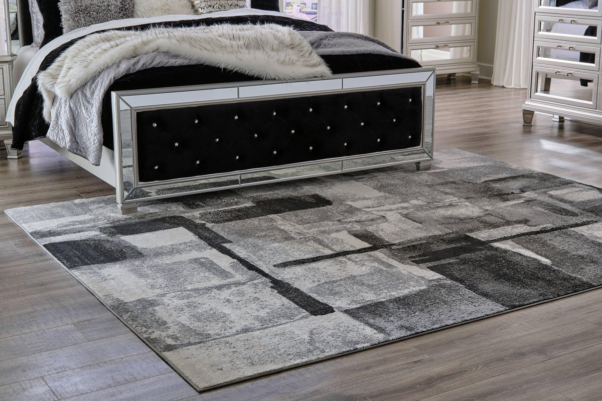 Medium Ashley Furniture Brycebourne 5'3" x 7'7" rug with intricate patterns, soft texture, and neutral colors for stylish home decor.