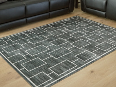 Medium Ashley Furniture Elderland washable area rug, 5' x 7', with a detailed pattern and soft texture, suitable for living rooms or bedrooms.