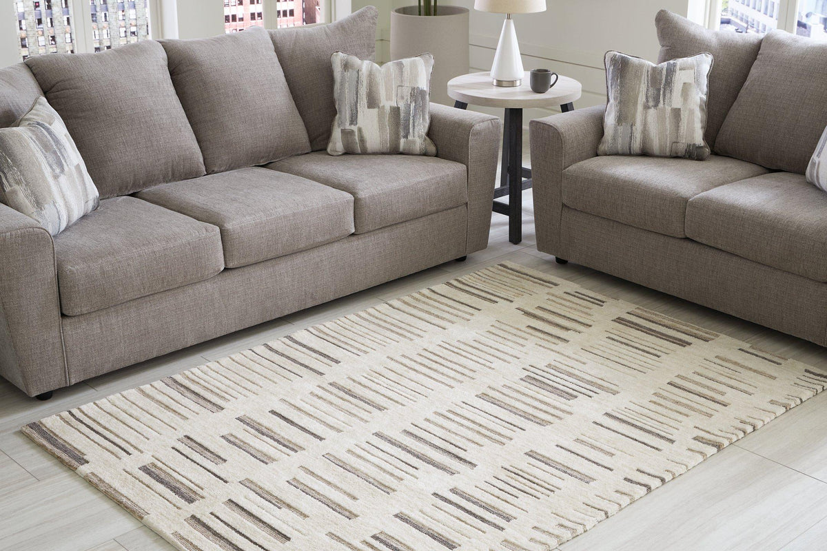 Medium Ashley Furniture Leesdale 5x7 rug with intricate patterns and neutral colors, perfect for living room or bedroom decor.