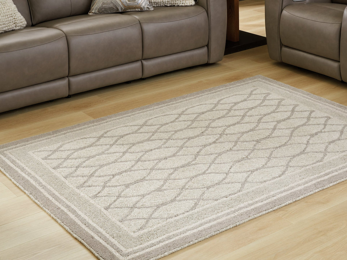 Medium Ashley Furniture Wimney Rug with intricate pattern, shown in a close-up view, suitable for living room or bedroom decor.