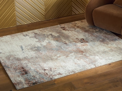 Ashley Furniture Jadenburg Rug in earthy tones, showcasing a textured pattern perfect for living rooms or bedrooms.