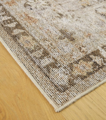 Close-up of Ashley Furniture Livdon washable rug featuring intricate pattern and soft texture in neutral tones.