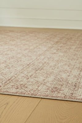 Close-up of the Ashley Furniture Lyamford Rug showcasing intricate woven patterns and textured fabric in neutral tones.