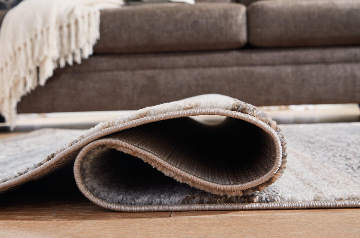 Medium Sethburn Rug by Ashley Furniture, showcasing a woven textile with neutral tones and textured pattern.