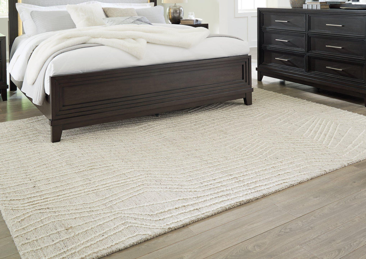 Medium Ashley Furniture Varahill Rug with intricate patterns and neutral tones, perfect for adding style to living spaces.