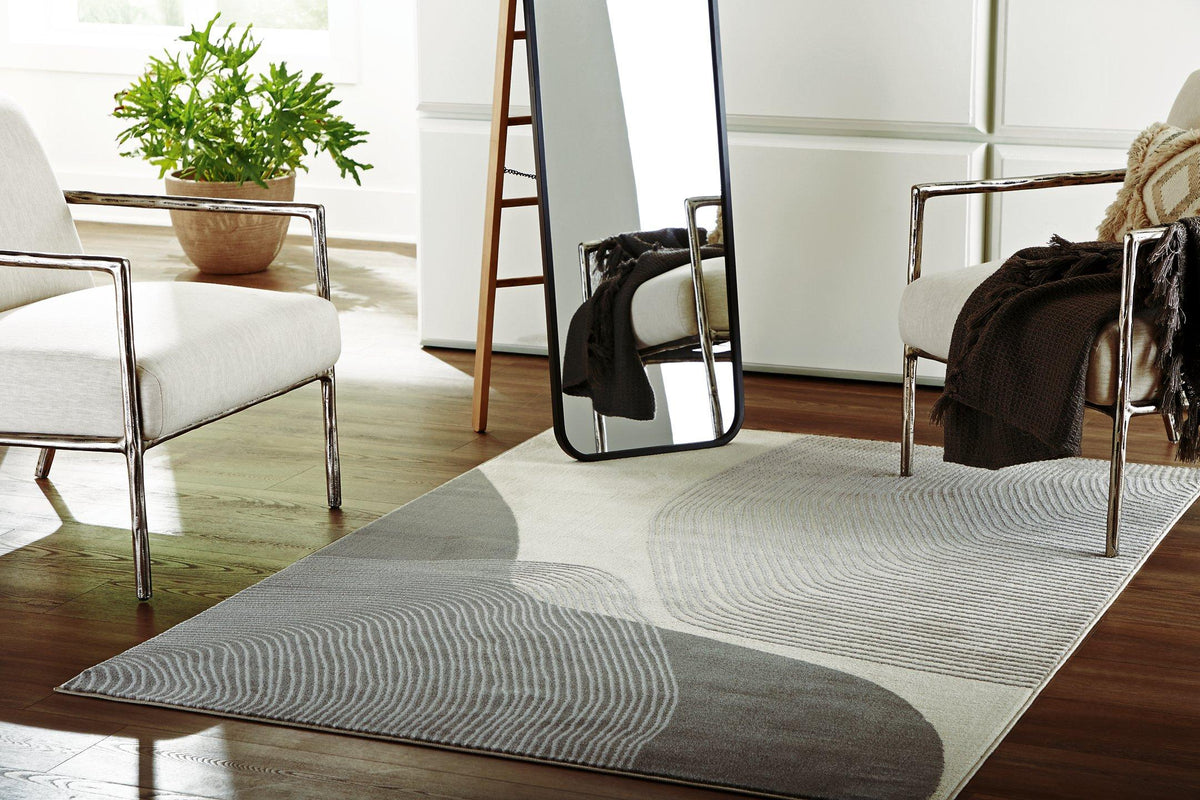 Medium Winderburg Rug by Ashley Furniture featuring intricate patterns and soft textures in neutral tones.