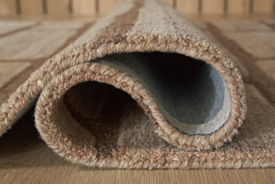 Close-up of the Ashley Furniture Orest Rug showing detailed woven pattern and rich texture in neutral tones.