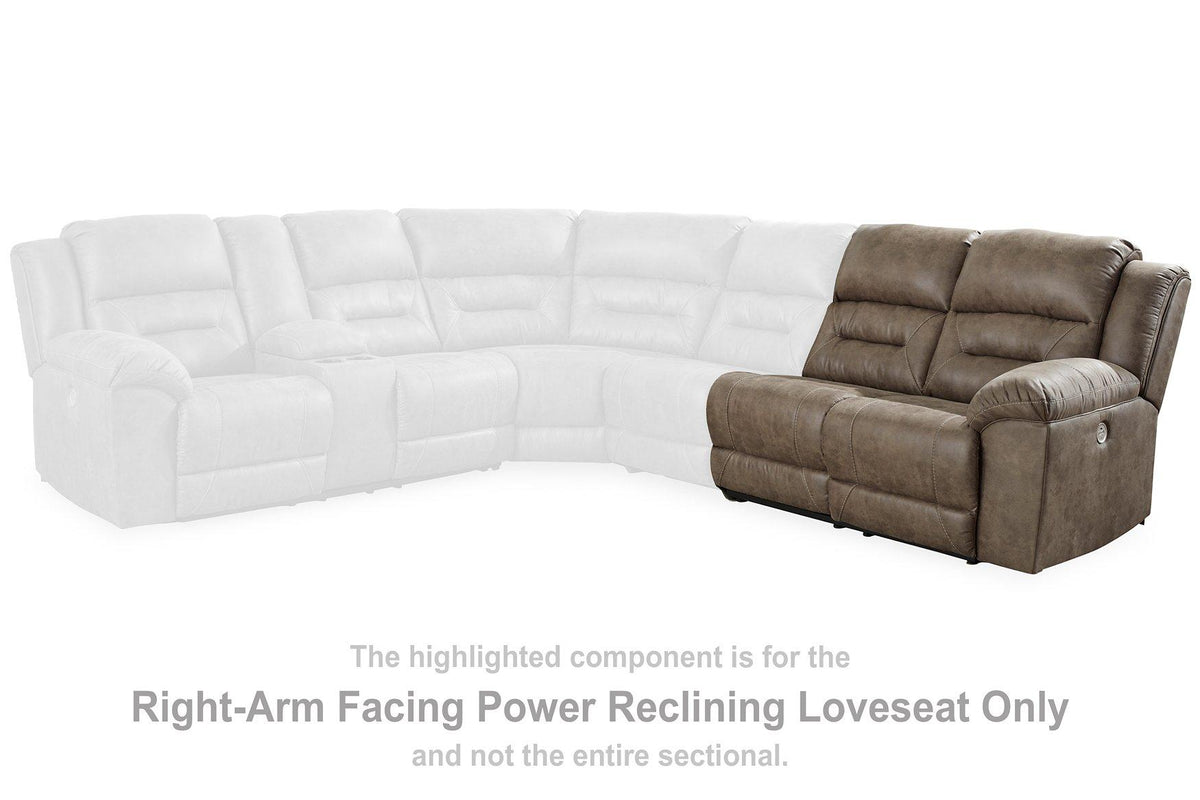Ashley Furniture Ravenel Power Reclining Sectional shown in a modern living room with plush cushions and dark fabric upholstery.