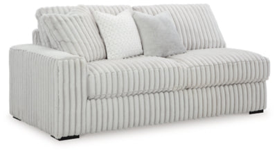 Ashley Furniture Stupendous sectional sofa with plush cushions and modern design, shown from an angled view in a stylish living room setting.