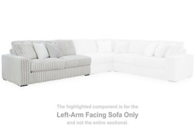 Ashley Furniture Stupendous Sectional sofa with plush cushions and neutral fabric, shown in a spacious living room setting.