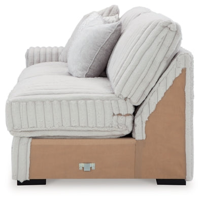 Ashley Furniture Stupendous sectional with plush cushions and modern design, shown in a spacious living room setting.