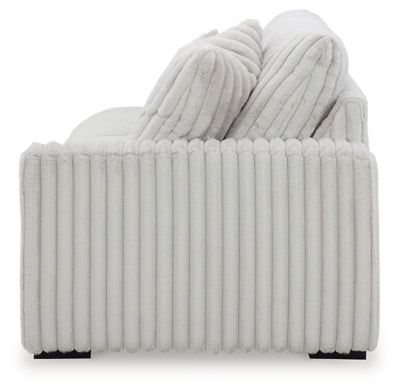 Ashley Furniture Stupendous Sectional sofa with plush cushions and wide armrests, shown in a modern living room setting.