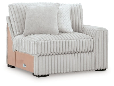 Ashley Furniture Stupendous sectional sofa shown from an angle, featuring plush cushions and modern design in a cozy living room setting.
